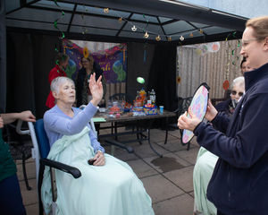 Patients taking part in activities at the opening of the courtyard.