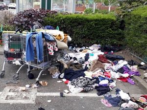 Supporting image for story: Fly-tippers dump unwanted clothes outside supermarket helping residents