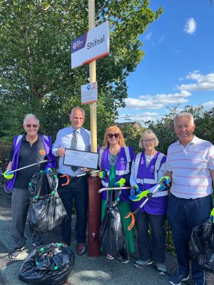 Roger Cox (second left) presents the cheque to the Friends of Wellington Station