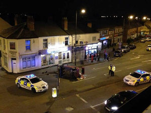 Supporting image for story: Woman arrested after car overturns on busy route