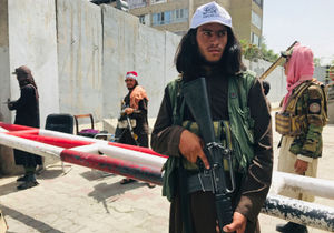 Taliban fighters stand guard at a checkpoint near the US embassy that was previously manned by American troops in Kabul
