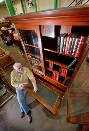 John Ridgway with the behemoth bookcase - he is 6ft 6in but it towers over him