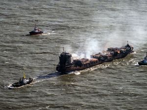 Tug boats shadow the Solong container ship as it drifts in the Humber Estuary off the coast of East Yorkshire