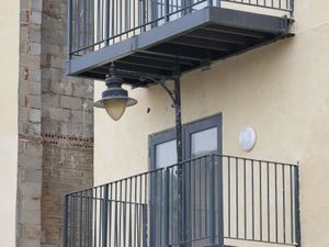 Supporting image for story: Developer builds balcony at block of flats around street lamppost