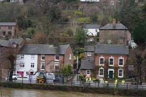 The swollen River Severn as flood defences are put in place along The Wharfage at Ironbridge in Telford. Photo: Nick Potts/PA Wire