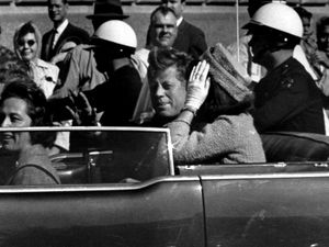 President John F Kennedy waves from his car in a motorcade approximately one minute before he was shot on November 22, 1963, in Dallas