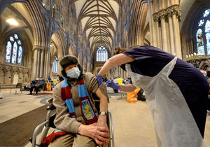 Villa fan Trevor Stokes, aged 86, from Burntwood, receives the vaccination from Mel Hayward