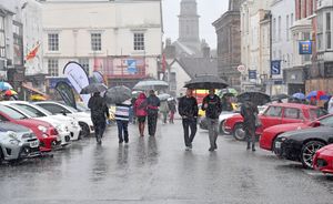 Visitors to the Bridgnorth Italian Moto Fest brave the horrendous downpours to view the cars on show
