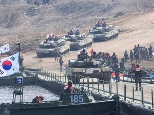 A South Korean army K1E1 tank crosses a floating bridge on the Imjin River during a joint river-crossing exercise between South Korea and the United States