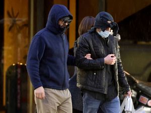 Former FBI informant Alexander Smirnov, left, walks out of his lawyer’s office in downtown Las Vegas after being released from federal custody in February 2024