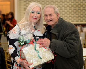 Sarah Bell of Outreach 4 Wolverhampton hands over a hamper to Anthony Owen from Bushbury