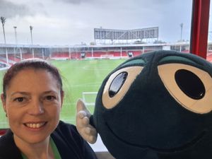 The NSPCC's Claire Rose with Buddy, the school's mascot, visiting Walsall FC.