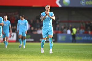 Walsall defender Aden Flint applauds the travelling supporters at Crawley.