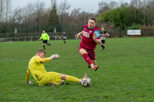 Dawley Town's Jake Challanor jumps over Shawbury goalkeeper Matty Cowap-Tait Picture: Alan Hayward