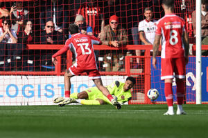 Walsall goalkeeper Myles Roberts denies Crawley attacker Harry McKirdy from the spot.