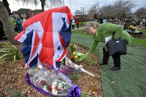 Pauline Hodgetts lays flowers