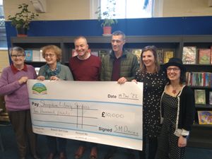 Supporting image for story: Library support group hands over £10,000 for new shelving