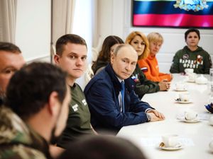 Vladimir Putin with volunteers