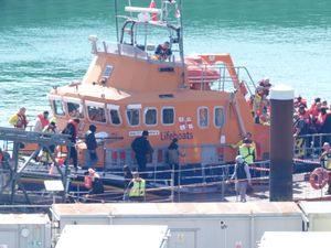 People believed to be migrants are taken into Dover