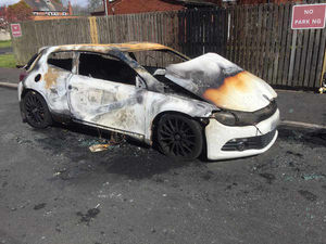 The burnt out car