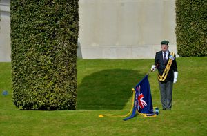 One of the many flags on display is lowered during the service