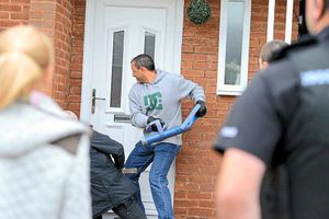 Police officers raid a property in Telford as the gangs year-long drugs conspiracy is brought to an end