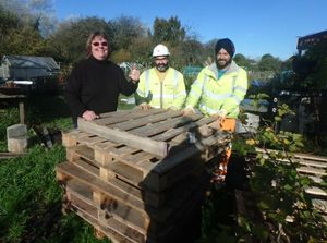 Chris McCreery receives the pallets from Gurvinder Singh and Balwant Singh who are working at junction 10