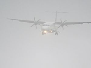 View of a plane through a misty sky