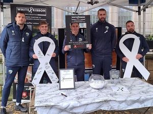 White Ribbon Day awareness raising at Bailey Head in 2023 with campaign supporters The New Saints FC.