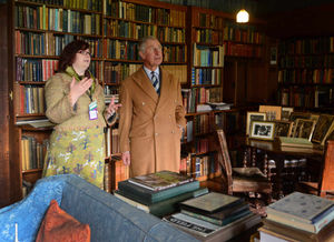 The Prince of Wales is shown around the library of Wightwick Manor with house steward Helen Bratt-Wyton