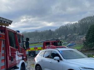 Supporting image for story: Fire crews tackle a blaze at a riverside bungalow in a Shropshire village