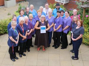 Staff at Chirk Court celebrate the results of a recent Care Inspectorate Wales (CIW) Inspection with Care Home Manager Jane Humphreys (centre).