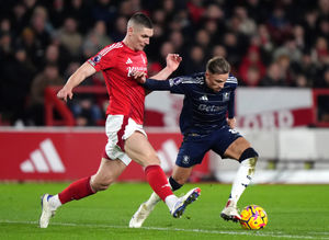 Nottingham Forest's Nikola Milenkovic (left) and Aston Villa's Matty Cash battle for the ball during the Premier League match at The City Ground, Nottingham. Picture date: Saturday December 14, 2024.