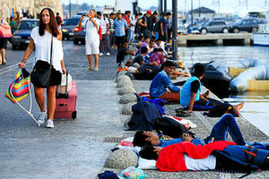 Refugees have risked their lives to escape to the holiday island of Kos, where they mix with tourists enjoying their break