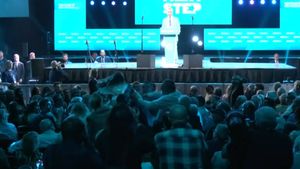 Climate Resistance protester interrupts Nigel Farage at Reform conference at the NEC in Birmingham.