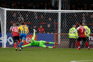 Conor Thomas of Cheltenham Town scores a goal to make it 1-1 from the penalty spot. (AMA)