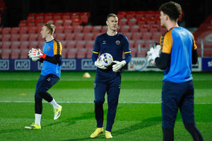 Joe Hart helps warm-up goalkeepers Matt Cox and Will Brook