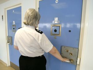 Prison officer checking a prison cell