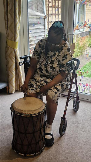 Resident at HC-One’s Perry Locks Care Home playing the African drums