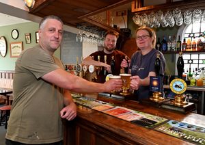Steve and Liz Evans and Joe Keay celebrate the return of the Fox and Goose after a year of work refurbishing it