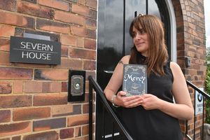 Author Emma Woodhouse is pictured with her book 'Mercy