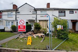 Barriers around the house, which was propped up by wooden supports