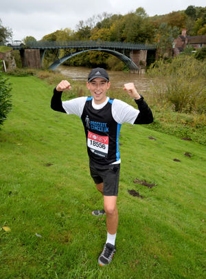 Jordan Evans celebrates finishing his marathon at The Woodbridge