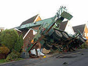 Supporting image for story: Crane topples onto house's roof