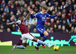 Aston Villa's Ashley Young and Leicester City's Harvey Barnes (right) battle for the ball