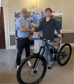 Managing Director Stephen Hughes and Rider Sam Kaye shaking hands