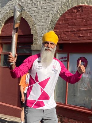 Dementia ambassador and Wolves fan Many Kang with the baton