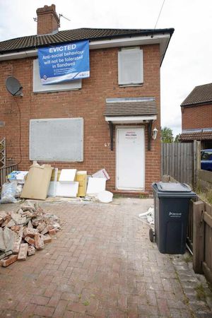 A sign on one of the now-empty homes telling of the eviction.