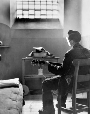 A prison cell at Shrewsbury jail (Dana Prison) in June 1958. The caption reads: 'Playing the blues - in a prison cell.' This unusual picture was taken by Express and Star chief photographer Bert Johnson.