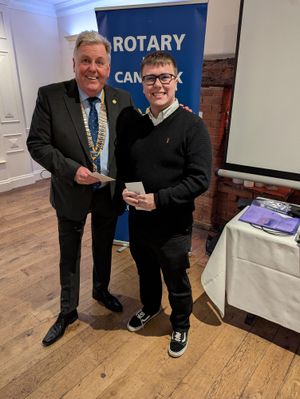 Rotary Club President David Marklew presenting a cheque to Ryan from Seasons Theatre Company 